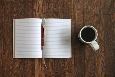 Blank Open Notebook And Coffee On Desk Good Stock Photos