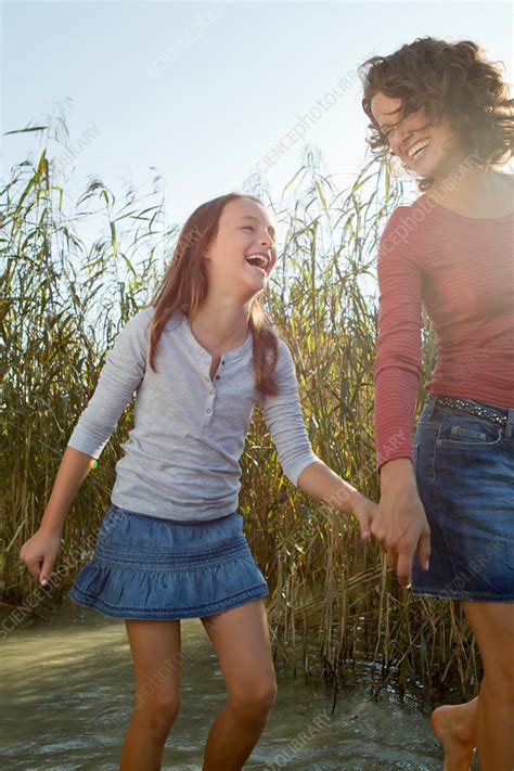 I hurt myself today to see if i still feel i focus on the pain the only thing that's real. Mother and daughter walking in pond - Stock Image - F005 ...