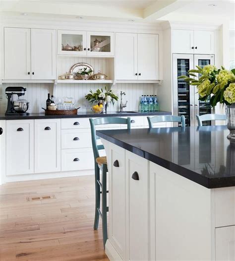 , white cabinets with black countertop design ideas. Two tone black and white kitchen features off white ...