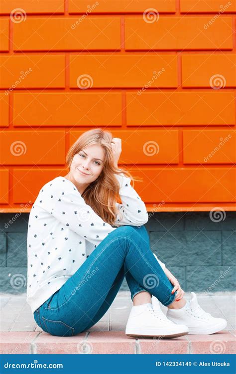 Pretty Attractive European Stylish Young Woman In Blue Jeans Sneakers