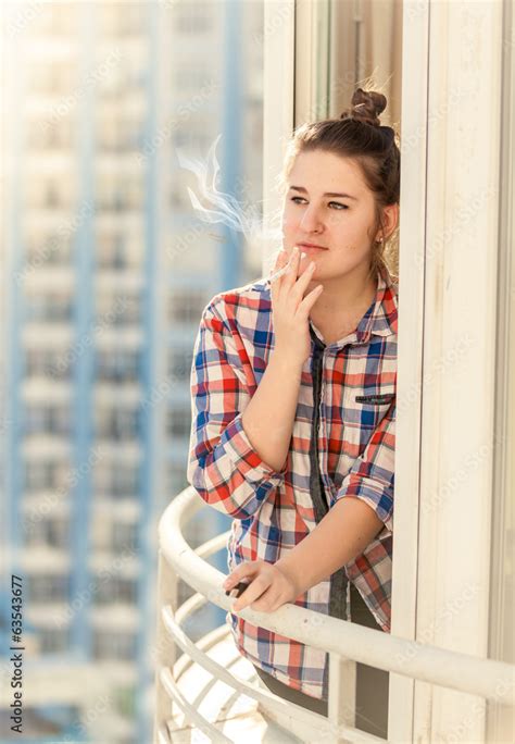 Beautiful Woman Smoking Cigarette On Balcony Stock Photo Adobe Stock