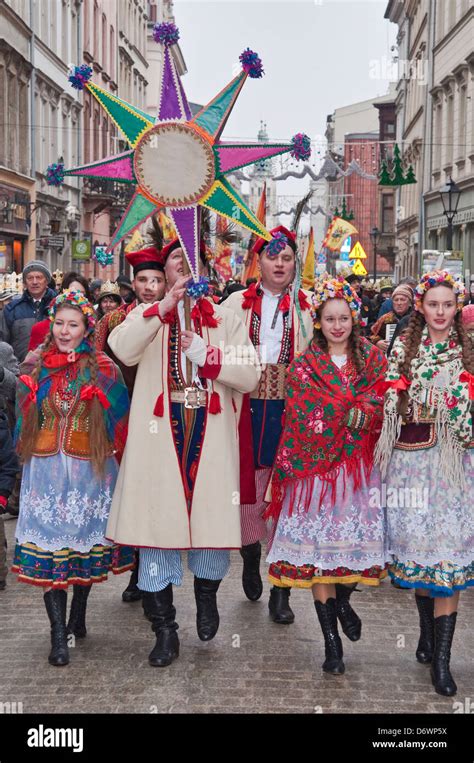 People In Traditional Costumes Singing Christmas Carols Carrying Star