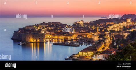 Aerial Panorama Of Dubrovnik Old Town At Night With Orange Sunset Sky