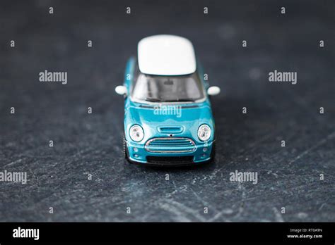 A Toy Teal Blue Mini Cooper S Metal Car In Macro Photographs On A Slate