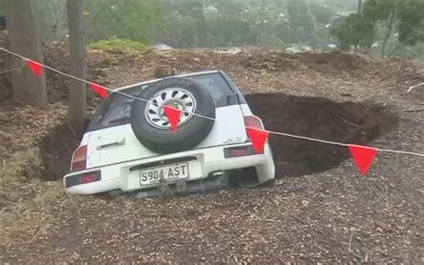 Couple Bruised After Sinkhole Swallows Car