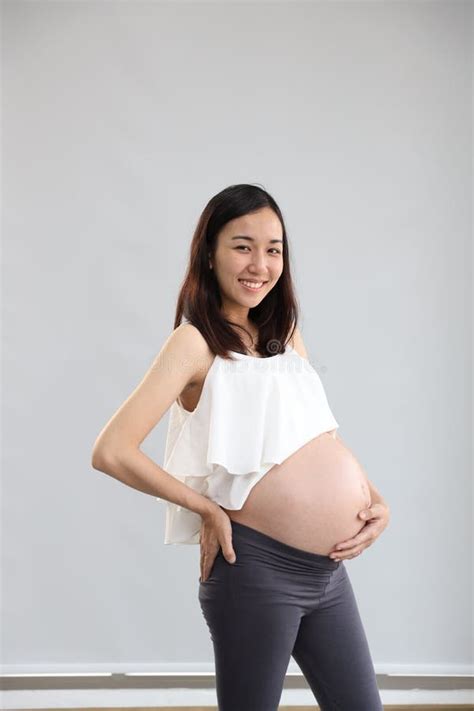 Full Length Young Asian Pregnant Belly In White Dress With Happy