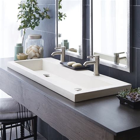 Trough bathroom sinks can be installed in a number of ways. Small Trough Bathroom Sink With Two Faucets