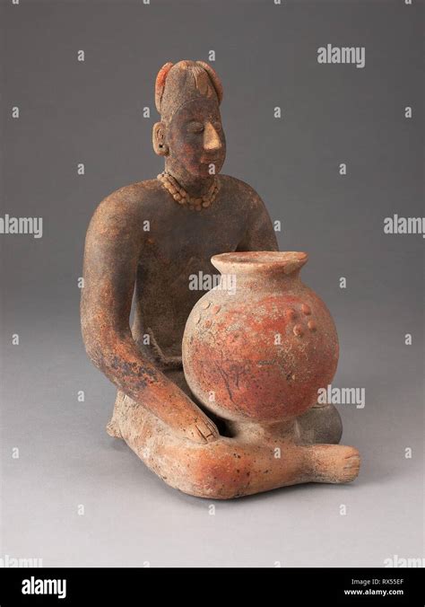 Seated Female Figure Holding A Vessel Colima Colima Mexico Date