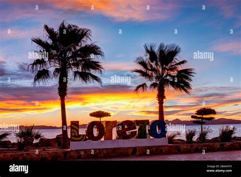 Sunrise Behind Loreto Sign With Palm Trees Malecon Loreto Baja