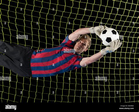 Soccer Player Catching Ball In Air Stock Photo Alamy