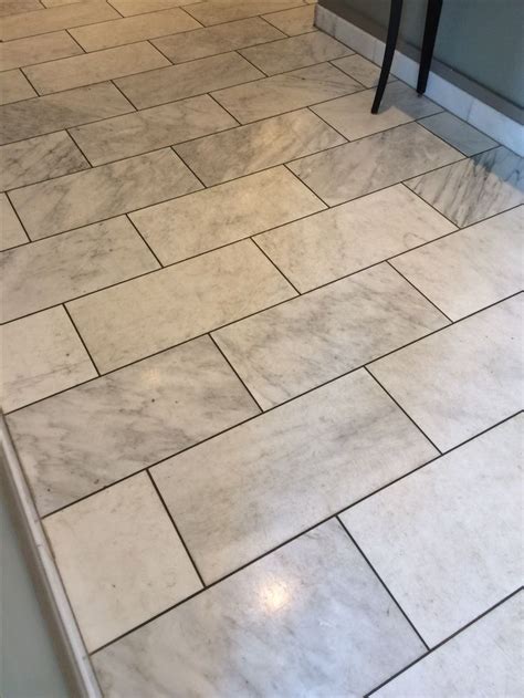 The contractor swears that there is no way that the grout stained the stone and that the grout is just making the what you're probably seeing is the moisture from grouting. White and gray marble with dark gray grout. | White tile floor, Floor tile grout, Grey floor tiles