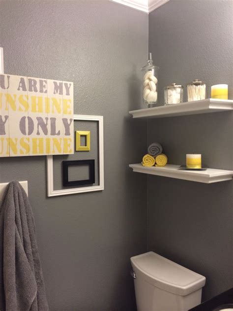 The combination of the blue, white, and yellow with the dark wood gives a nautical feel to this coastal bathroom. Yellow and Grey Bathroom | Ideas for My New Home!! | Pinterest