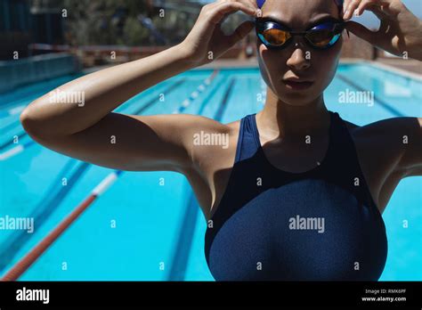 Young Female Swimmer Wearing Swim Goggle At Swimming Pool Stock Photo