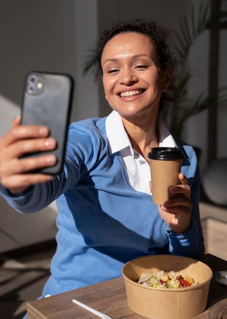 Free Photo Smiley Woman Enjoying Takeaway Food And Taking Selfie