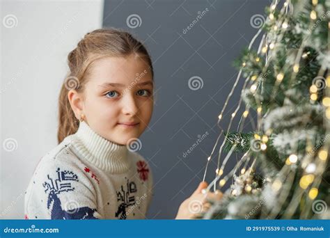 Merry Christmas And Happy Holidays Child Girl Is Decorating Christmas