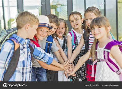Portrait Of School Pupils Outside Classroom Carrying Bags Stock Photo