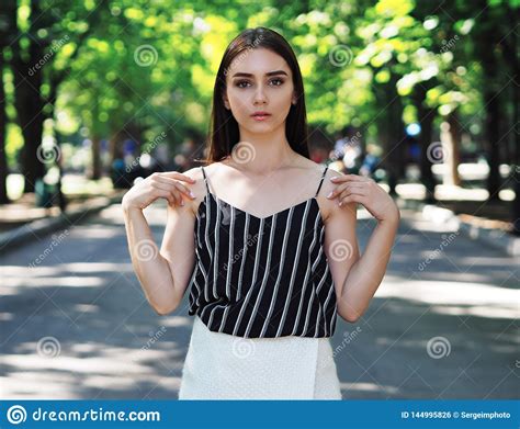 Young Girl Model Posing At Park Looking Forward Portrait Stock Photo