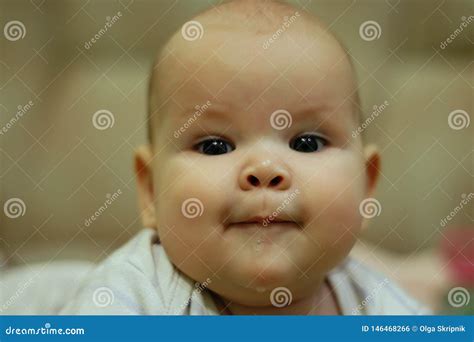 The Baby Is Drooling Smiling At The Camera Close Up Portrait Stock