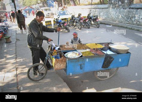 A Nepalese Man Selling Organic Rice Grains Nuts And Spices From His Bike In Kathmandu Stock