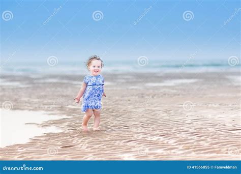 Beautiful Laughing Toddler Girl In Blue Dress At Beach Stock Image