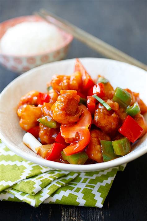 A steaming hot bowl of white rice with a generous scoop of fried chicken and crunchy vegetables in a perfectly balanced sweet. sweet and sour chicken cantonese style recipe