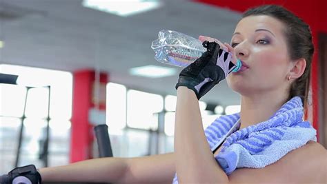 Sportswoman Drinking Fresh Water In The Gym Enjoying Rest Between