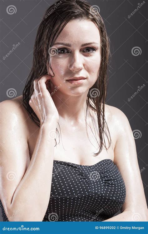 Portrait Of Caucasian Sensual Brunette Touching Neck And Showing Wet