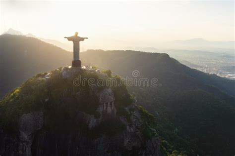 Christ The Redeemer Statue On Top Of Corcovado Mountain At Sunset Rio