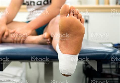 Close Up Bottom View Of A Female Athletes Foot In An Ankle Tape Job