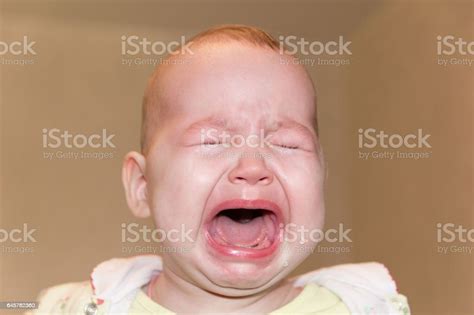 Portrait Of A Crying Baby Tears On The Face Stock Photo Download