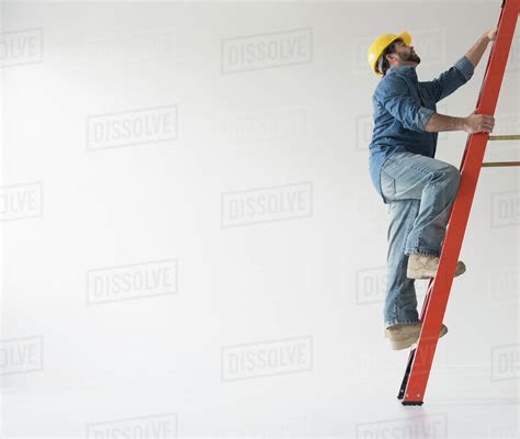 Man Climbing Up Ladder Stock Photo Dissolve