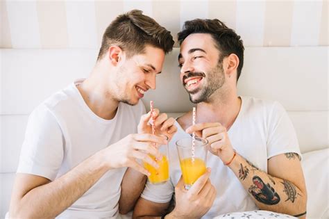 Free Photo Laughing Gay Couple Enjoying Juice In Bed