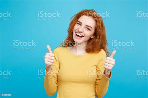 Portrait Of Young Stylish Freckled Girl Laughing With Showing Thumps Up