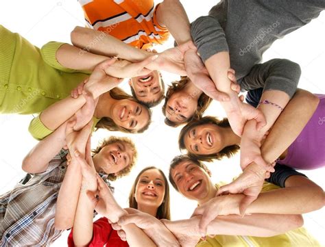 Group Of Smiling Teenagers Staying Together And Looking At Camera