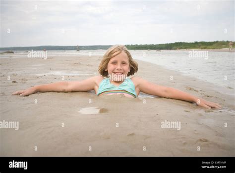 Portrait Of A Girl Buried In Sand Grand Beach Manitoba Stock Photo