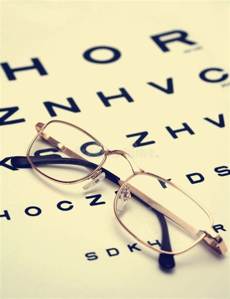 Glasses On Eye Test Letter Chart On Optician Table Stock Photo Image