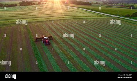 Aerial View Of Red Massey Ferguson 1880 Tractor Mowing And Cutting