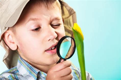 Child Looking Through A Magnifying Glass Stock Photo By ©voyagerix 61606235