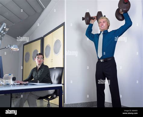 Office Worker Lifting Weights Stock Photo Alamy