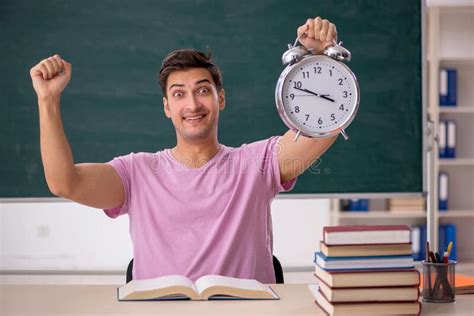 Young Male Student Preparing For Exams In Time Management Concep Stock