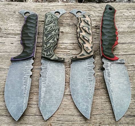Four Knives With Different Patterns On Them Sitting On Top Of A Piece