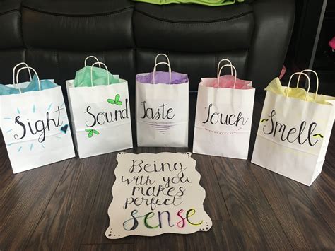 Five Bags With Sayings On Them Sitting On A Table Next To A Black Chair
