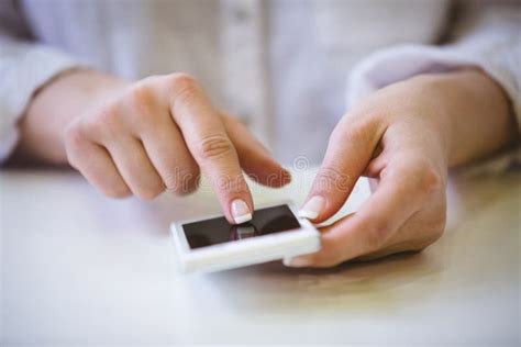 Close Up Of Businesswoman Touching Cellphone On Desk At Office Stock