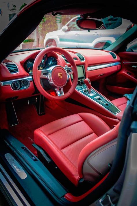 The Interior Of A Sports Car With Red Leather Seats And Steering Wheel