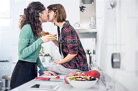 Romantic Lesbian Couple Kissing In Kitchen Stock Photo Download Image