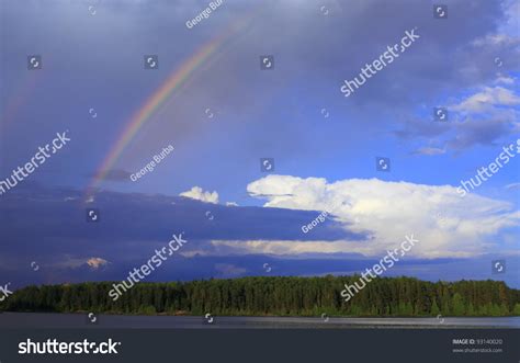 Rainbow Breaks Through Storm Clouds After Stock Photo