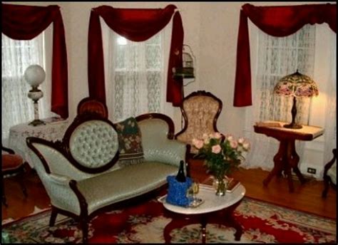 A Living Room Filled With Furniture And Windows Covered In Red Draping
