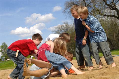 Children 6 9 Play Fighting On Playground Lizenzfreies Stockfoto