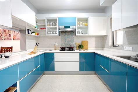 A Kitchen With Blue Cabinets And White Counter Tops