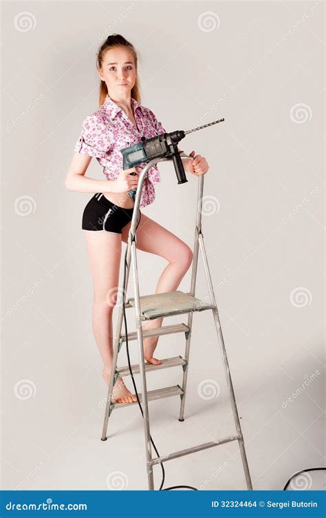 Woman With Puncher On Ladder Stock Photo Image Of Fashion Drill